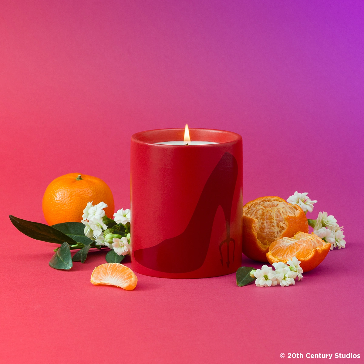 Everybody Wants to Be Us Candle in red ceramic with a stiletto graphic surrounded by mandarin oranges.