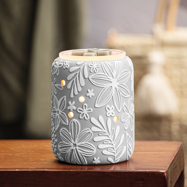 Scentsy Rooftop Garden Wax Warmer featuring a matte grey ceramic body with hand-painted white embossed flowers and glowing vent holes.
