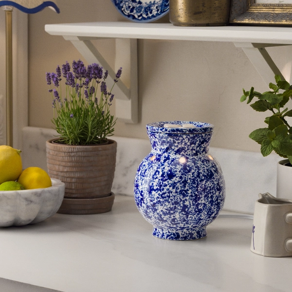 A 6.5-inch ceramic Scentsy Blue Spongeware Electric Fragrance Melter featuring a hand-painted mottled blue and white pattern on a kitchen counter.