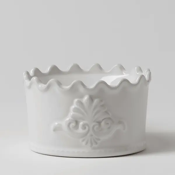 The Scentsy Classic Crest Electric Fragrance Melter featuring a white scalloped ceramic rim and embossed traditional scrollwork details.