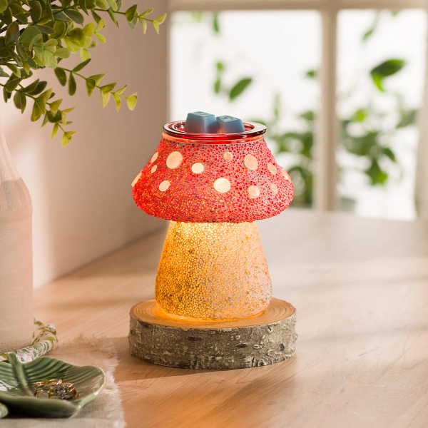 The Scentsy Cute as a button Wax Warmer featuring a handmade mosaic glass mushroom design with a red polka dot cap and glowing golden stem.