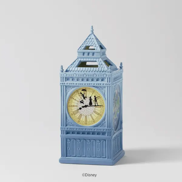 Disney Peter Pan Wax Warmer glowing on a counter, featuring an 11-inch dark ceramic clock tower with illuminated character silhouettes.