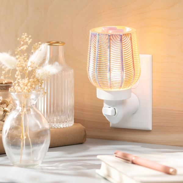 Scentsy Pearled Gatsby Mini Wax Warmer plugged into a wall, featuring ribbed glass with a shimmering iridescent Art Deco finish.