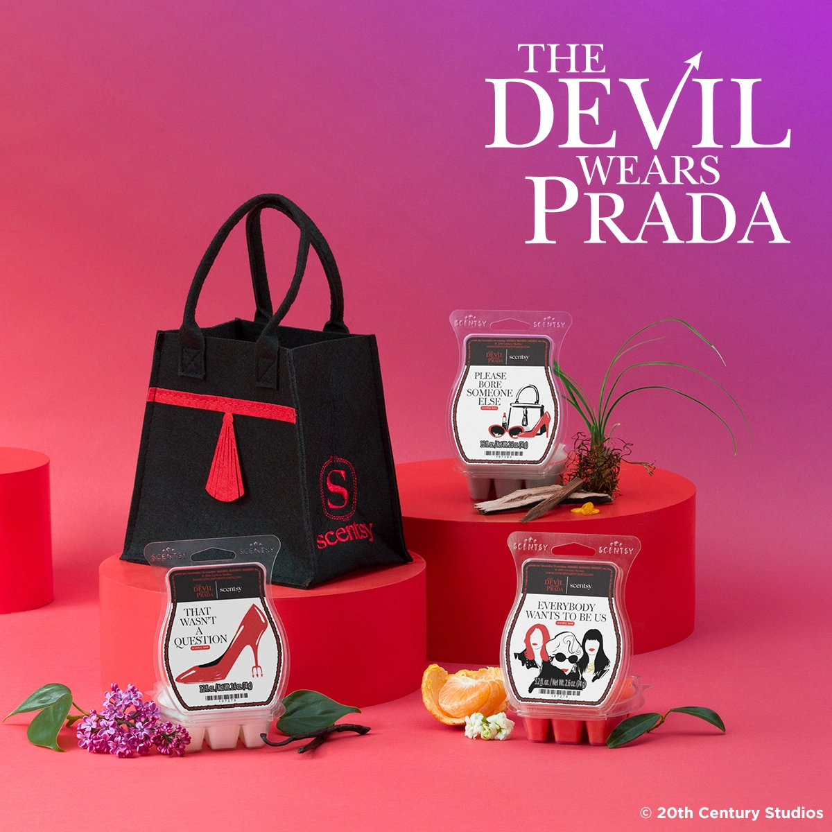 The Devil Wears Prada Scentsy collection featuring three chic wax bars and a black felt designer bag displayed on red pedestals against a vibrant magenta background